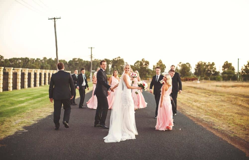 A group photo with bridesmaids and groomsmen.