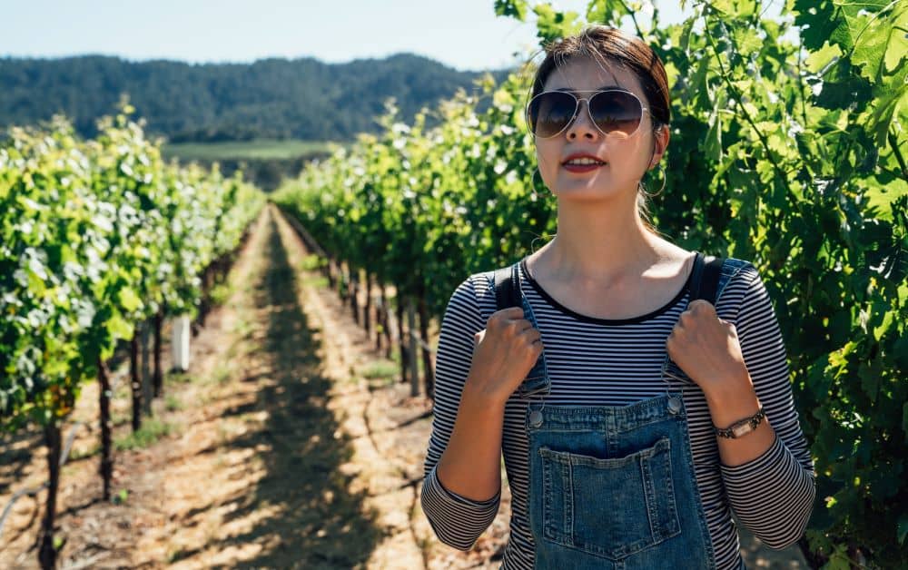 A woman on vineyard during a wine tour.